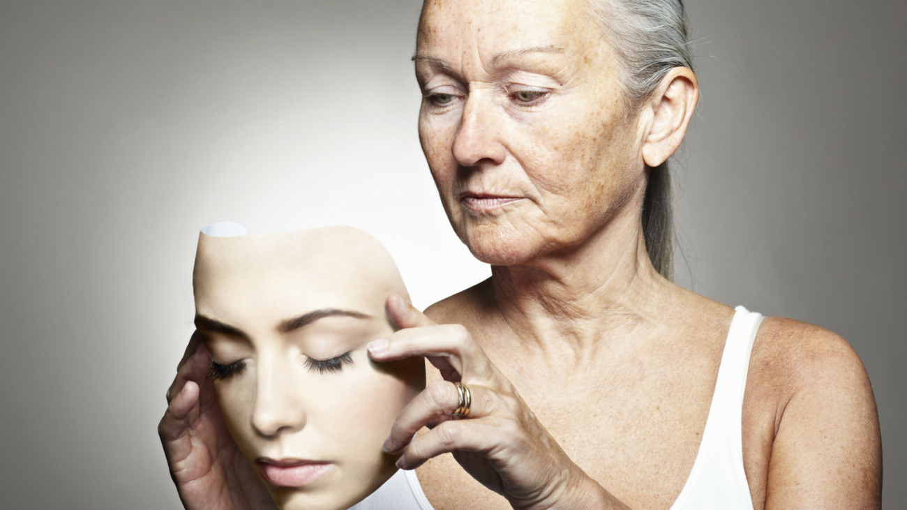 Older woman holding young mask